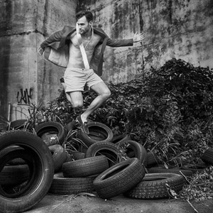 Alex Lago, model -  Alex jumping over tires.