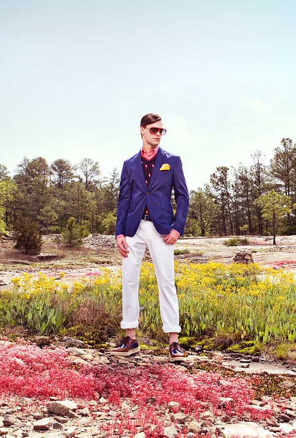Alex Lago - model - Alex standing in a field wearing a purple jacket
